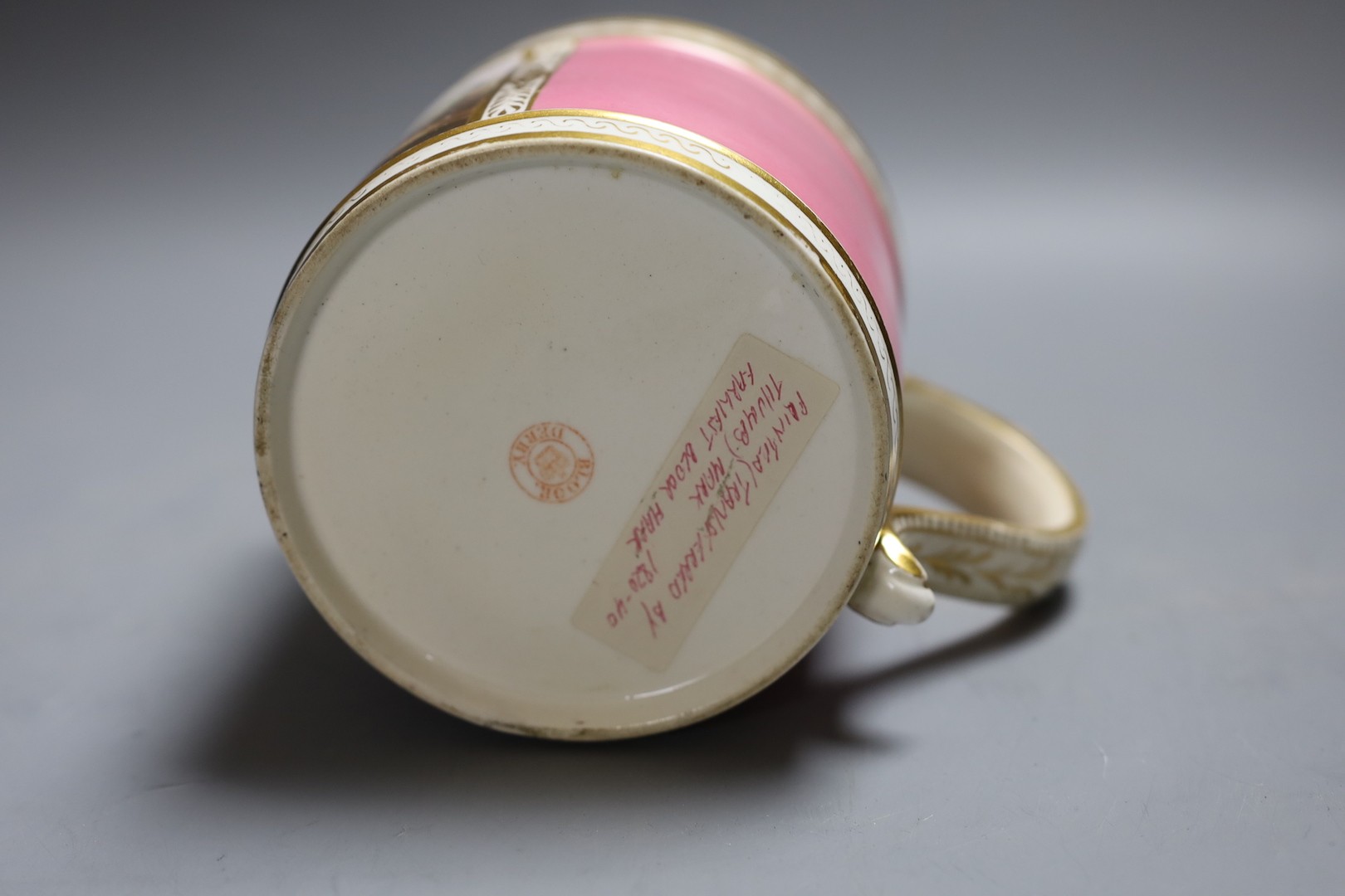 A Derby porter mug of large size painted with birds in a garden scene within a gilt panel on a pink ground c.1825, Red circle mark 11.5cm